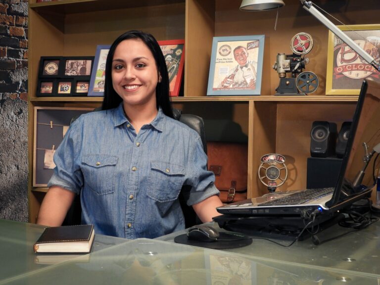 woman in blue button up shirt smiling
