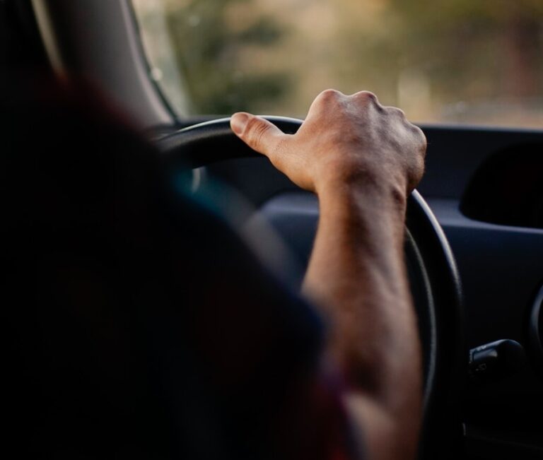 person driving car during daytime